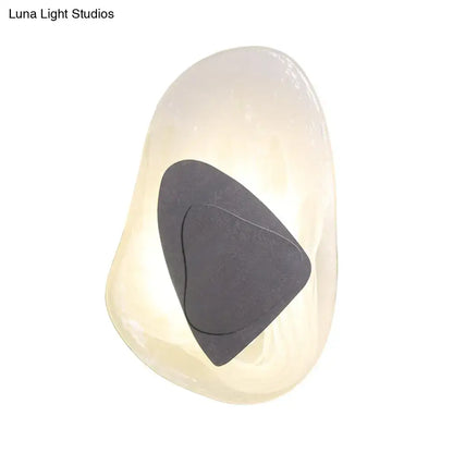 Modern abstract clear glass rock wall sconce with smooth white stone and dark gray triangular inlay for dining room direct wired electric