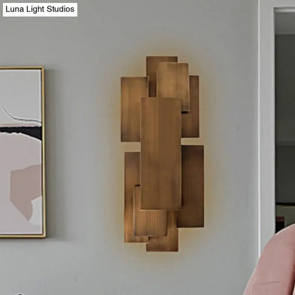 Modern abstract dark wood wall sconce with layered rectangular panels in a geometric pattern direct wired 220v-240v lighting