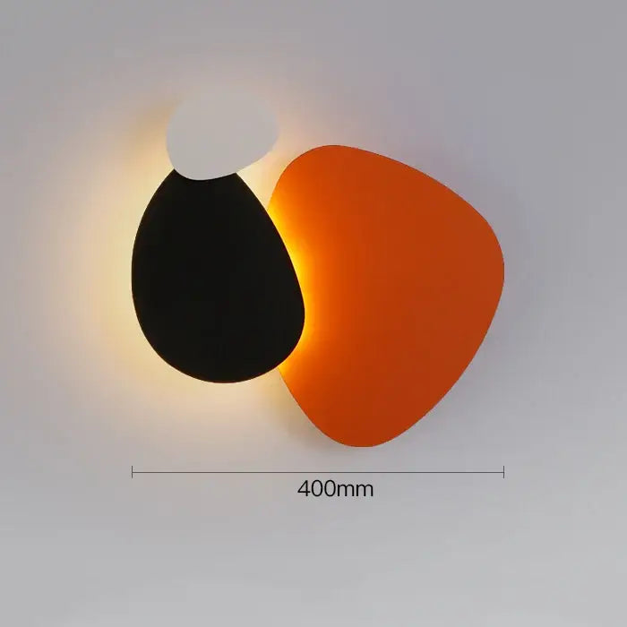 Modern abstract geometric art wall lamp with black teardrop and orange triangle shapes for bedroom and living room