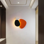 Modern abstract geometric art wall lamp with overlapping black white and orange shapes for bedroom and living room