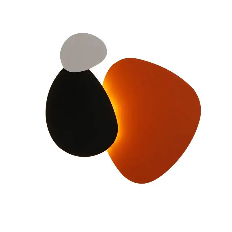 Modern abstract geometric art wall lamp with overlapping matte black gray and amber-orange shapes for bedroom and living room
