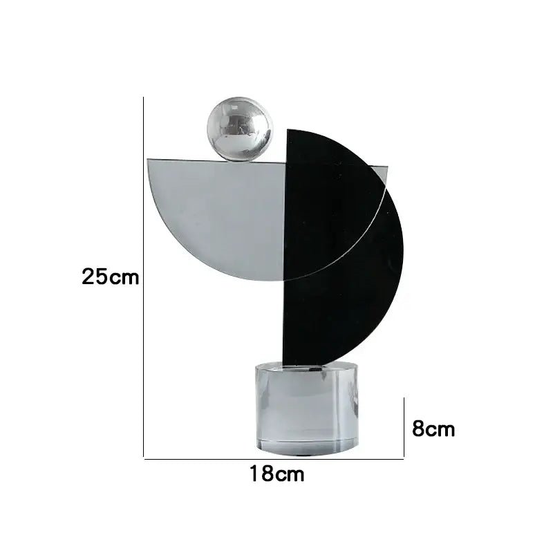 Modern abstract geometric crystal ornaments ring featuring sleek black silver crescent and chrome sphere on acrylic base