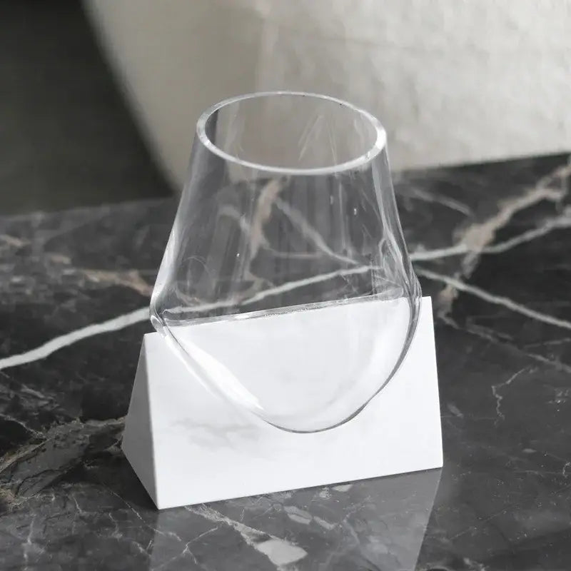 Modern abstract glass vase with geometric design and clear decorbites abstract glass resting on white marble base decor