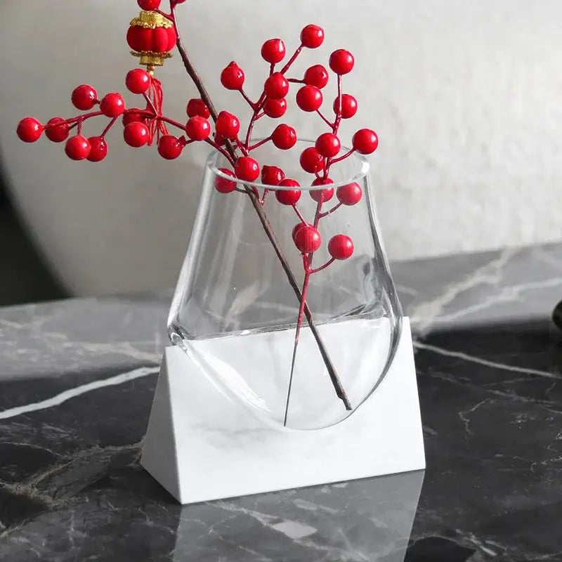Modern abstract glass vase with white marble base holding red berry branches for decorbites abstract glass decor