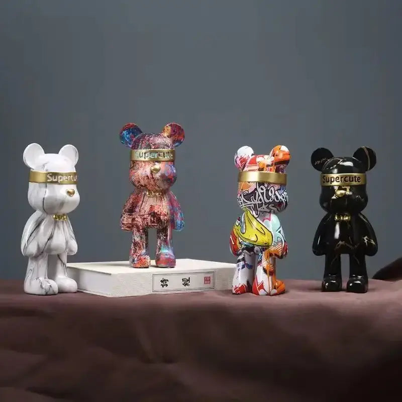Four stylized bear figurines with graffiti patterns and gold bands in white marble finish for home decor by decorbites graffiti bear