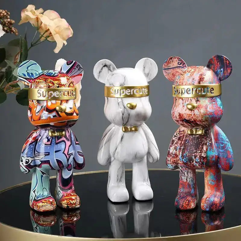 Three stylized bear figurines with colorful graffiti and marble finishes and gold bands for home decor by decorbites graffiti bear
