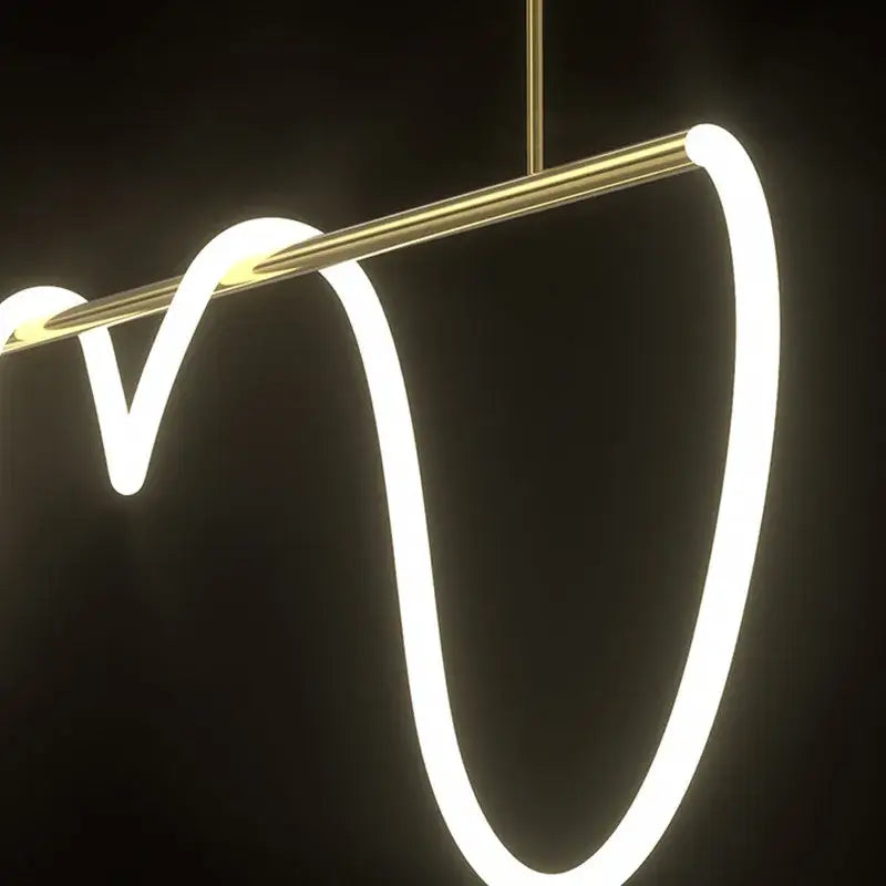 Modern gold-toned pendant light with sleek curved led strip design in decorbites lines chandelier for dining room decor