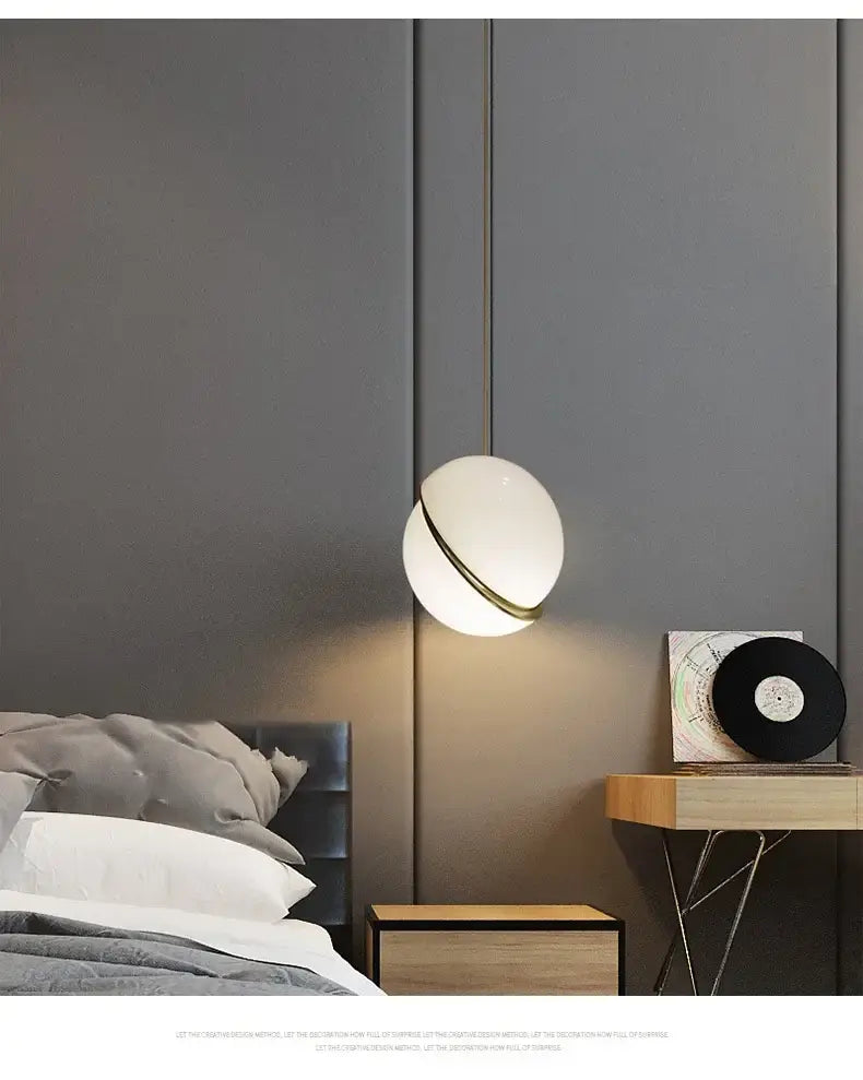 Modern acrylic ball pendant lamp with a frosted glass globe and metallic ring accent for living room lighting