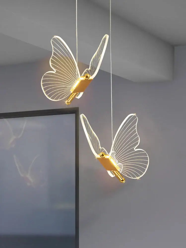 Two elegant translucent acrylic butterfly led chandelier pendant lights with gold bodies for bedroom lighting decorbites butterfly led