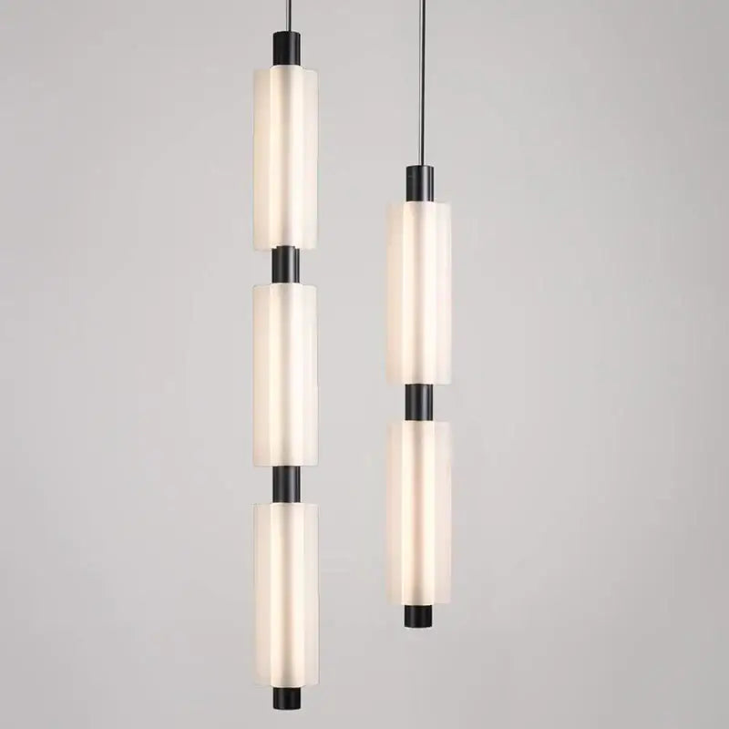 Modern acrylic minimalist pendant lights with frosted glass cylinders and matte black metal accents for bedroom decorbites pendant lights