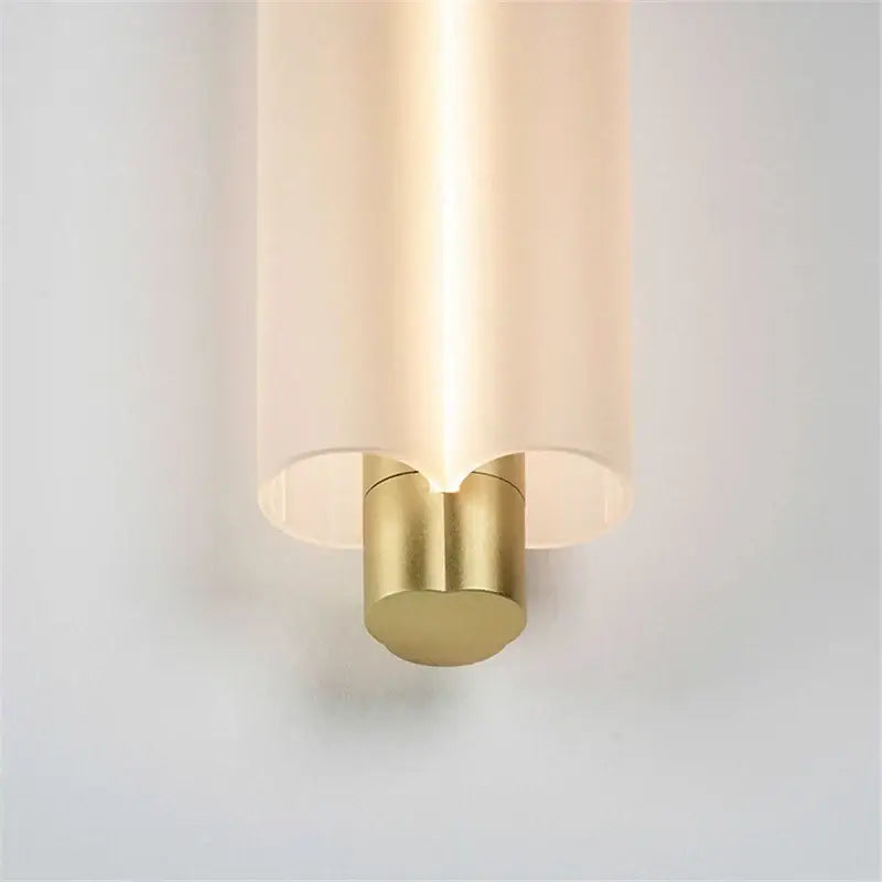 A sleek acrylic minimalist pendant light with off-white glass shade and brushed brass finish for modern decorbites decor
