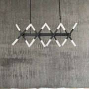 DecorBites™ modern acrylic tube island pendant light in black and white with intersecting angular bars for dining room lighting