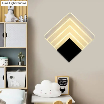 Modern aged silver and black square led wall sconce with diamond-shaped layered design and warm white led lighting