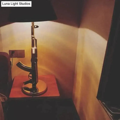 Modern ak47 gun lounge floor lamp with rifle-shaped black base and silvery gold lustre for bedroom lighting
