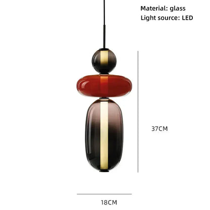 Modern glass pendant lights with colorful glass ball design in bold red and dark gradient accented by gold stripes