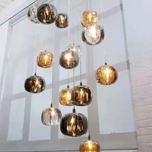 A modern decorbites crystal led chandelier with amber gold and clear spherical glass pendants for living room decor