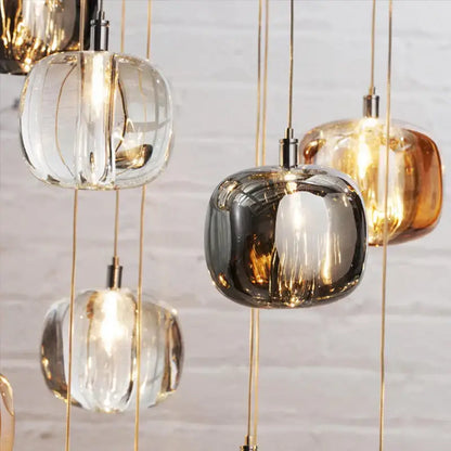Modern amber and gold crystal led chandelier with clear smoked glass and gold-toned metal pendant lights for living rooms