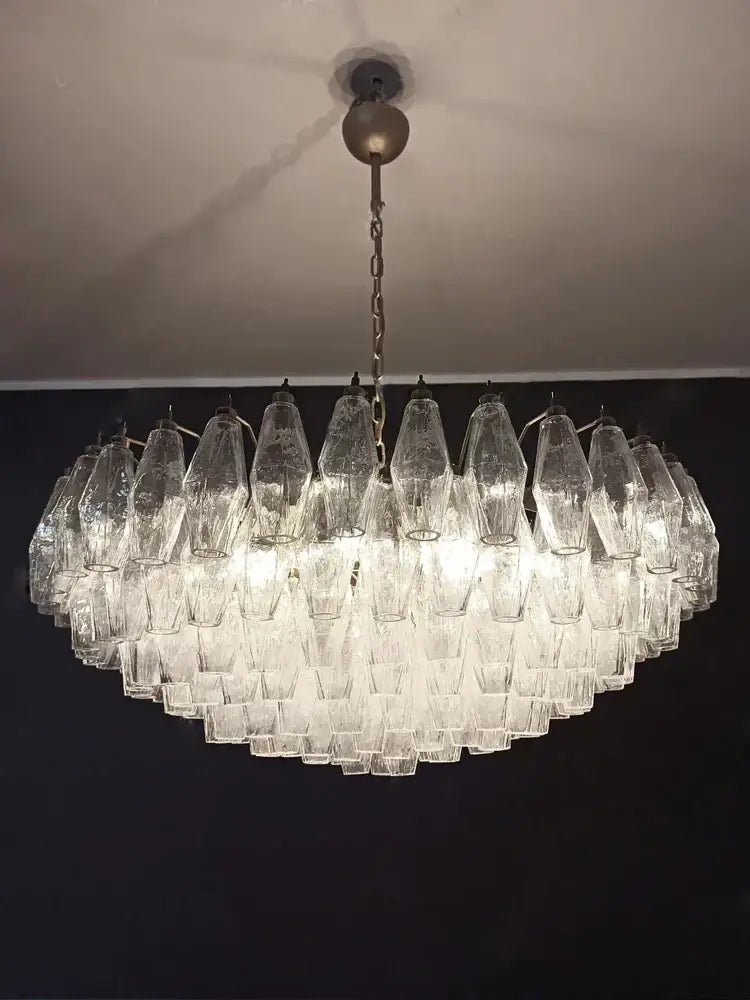 A modern amber and gray glass chandelier with colorful gray glass shades in concentric circles for dining room decorbites luxury light