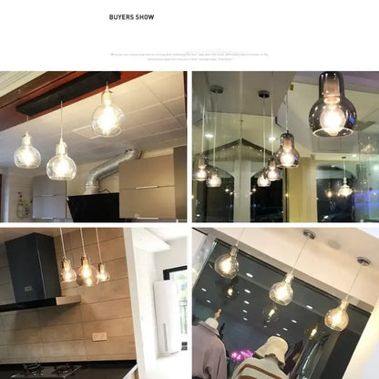 Modern amber and gray glass pendant lights with warm glowing bulbs and sleek metal fixtures for dining room use