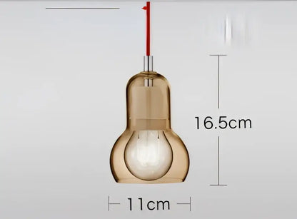 A sleek amber-tinted glass pendant light with red cord suspension for modern dining room glass pendant lights