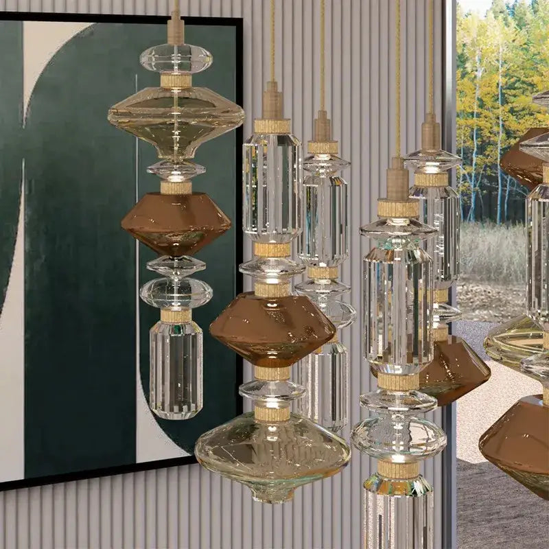 Modern amber and brown glass ballet pendant lamp with clear and amber shades and gold metal fittings for dining room