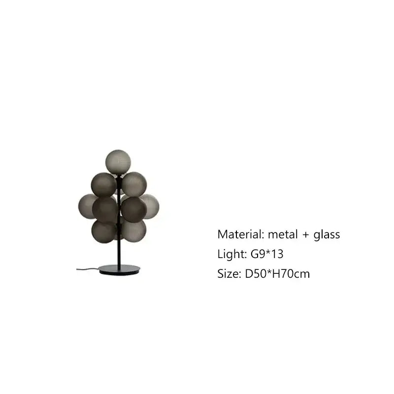 Modern amber bubble glass table lamp set featuring sleek black metal frame and frosted gray glass spheres in living room