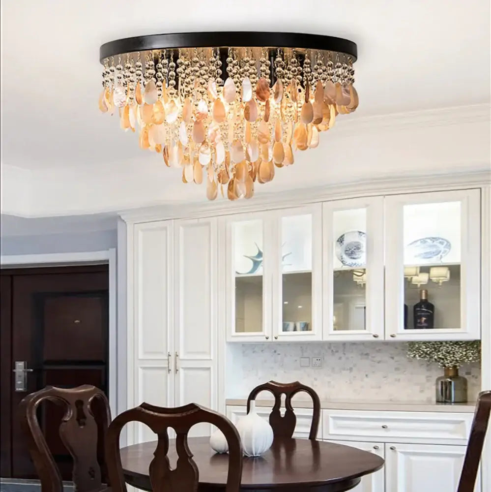 Modern amber and clear crystal led ceiling lamp with black frame and cascading shell pendants for living room decorbites crystal led