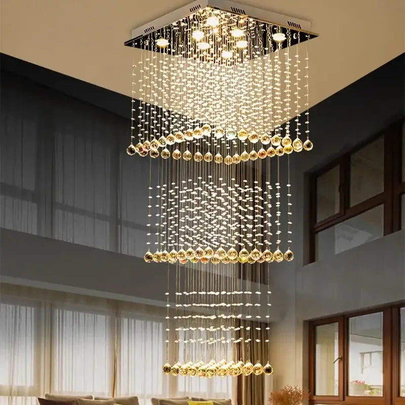 Modern amber and clear crystal teardrop stairwell chandelier with cascading tiers from a sleek metallic frame decorbites crystal teardrop