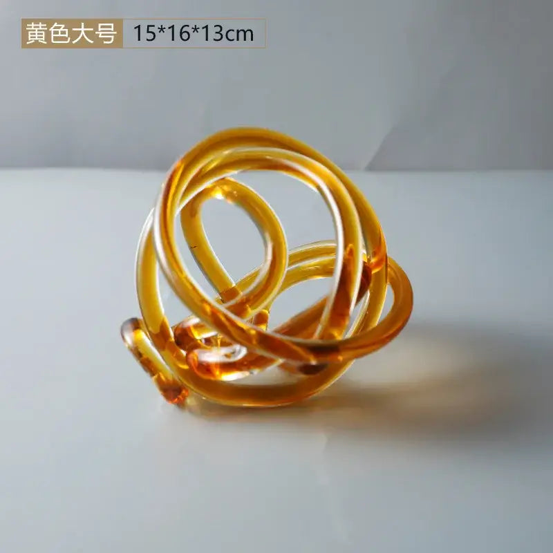 Translucent amber glass knot twist sculpture with smooth intertwined loops for modern living room decorbites decor
