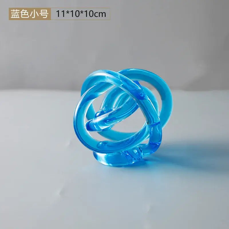 Modern amber and clear glass knot twist sculpture with translucent blue plastic interlocking rings decorbites glass knot decor