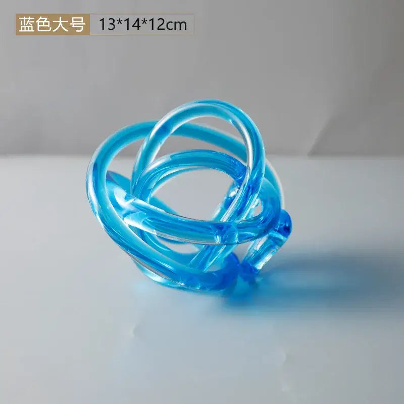 Modern amber and clear glass knot twist sculpture featuring a translucent blue coiled decorbites glass knot design