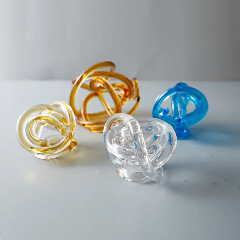 Modern amber and clear glass knot twist sculpture with intricate loops and polished finish for living room decorbites decor