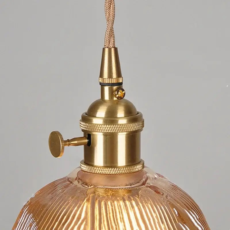 Brass-finished pendant light with ribbed amber-tinted copper glass led shade for modern kitchen decorbites copper glass