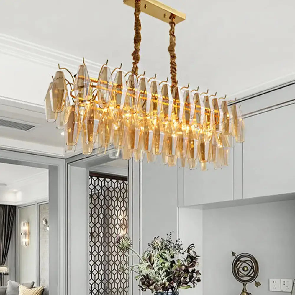 Modern amber crystal oval island light fixture featuring a golden chandelier with amber glass crystals for dining room