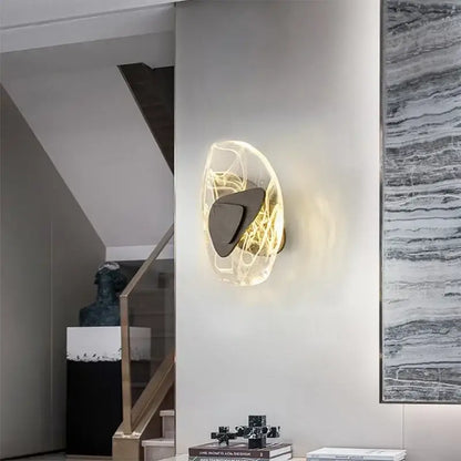 Modern amber crystal wall lamp with translucent glowing orb and dark bronze metallic accent for bedroom decorbites crystal wall lamp