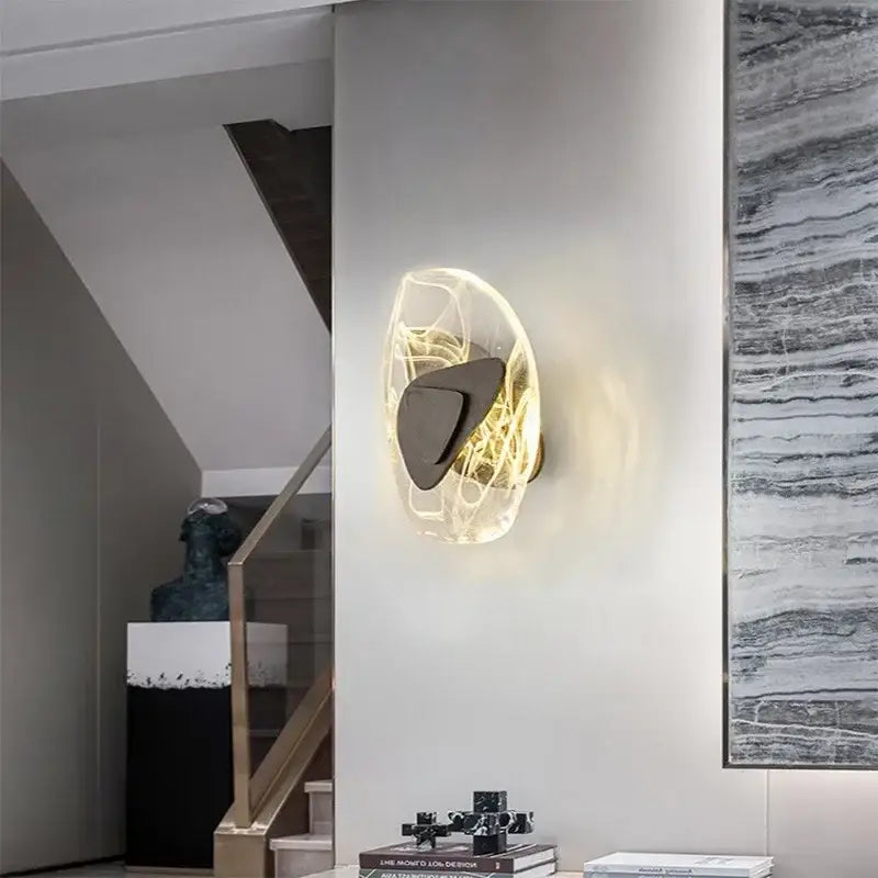 Modern amber crystal wall lamp with translucent glowing orb and dark bronze metallic accent for bedroom decorbites crystal wall lamp