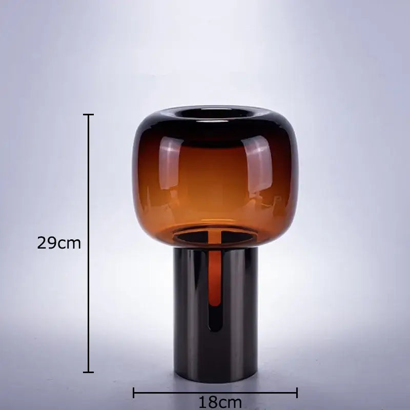 A sleek 29cm amber dark glass vase with a rounded top and black base for decorbites dark office desk decor