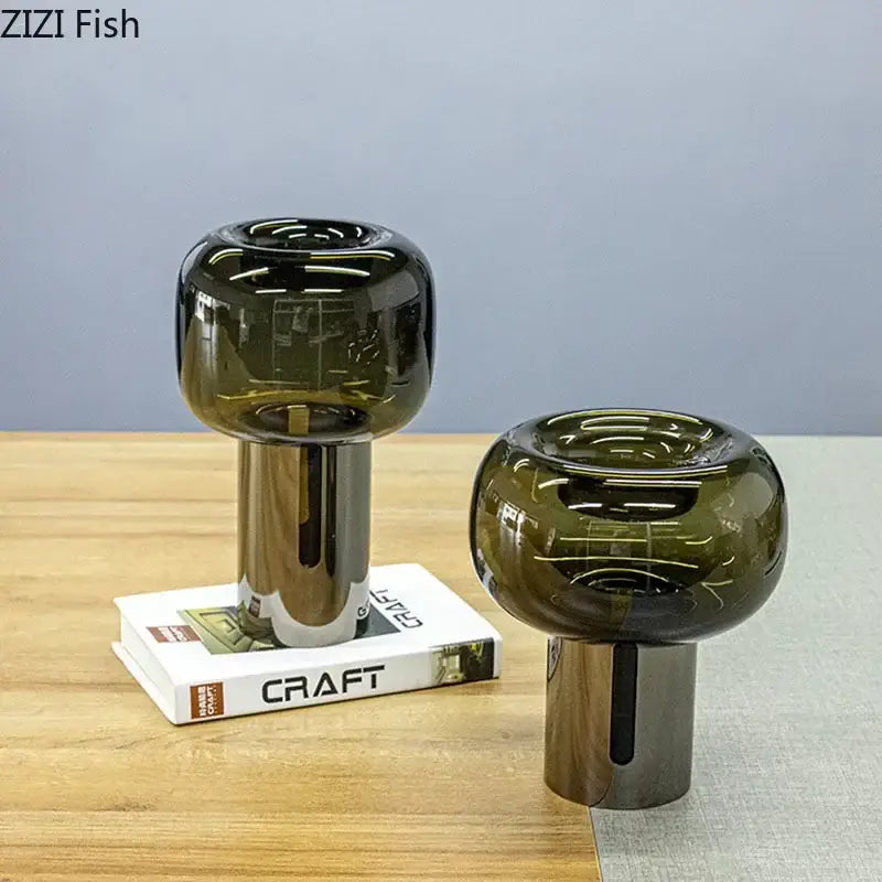 Two sleek modern decorbites dark glass vases with amber hue and metallic silver bases for office desk decor