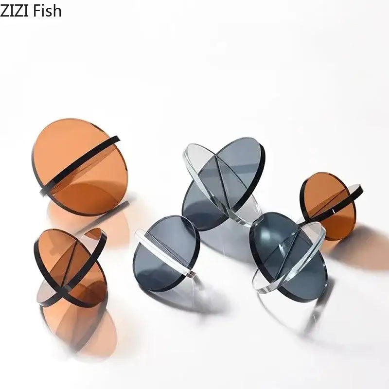 Modern amber geometric cross ornaments living room bookends with clear and amber glass discs and black silver crossbars by zizi fish