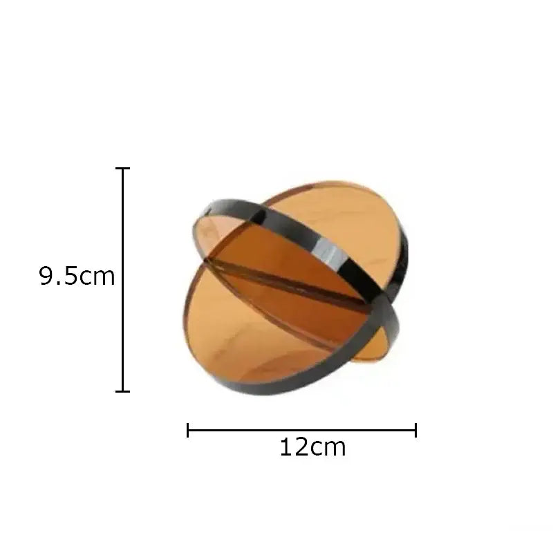 Modern amber geometric cross ornaments featuring a sleek amber acrylic orb with a black metallic band for living room decorbites geometric cross bookends