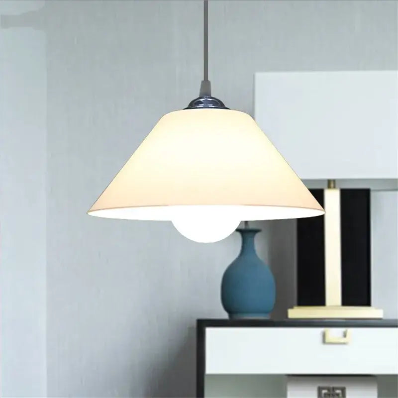 Modern cream-colored conical pendant light with iron finish and black fixture ideal for dining room lighting