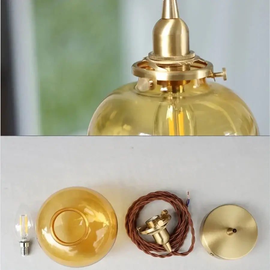 Modern amber glass ball led pendant light with gold-toned brass and translucent globe for dining room lighting