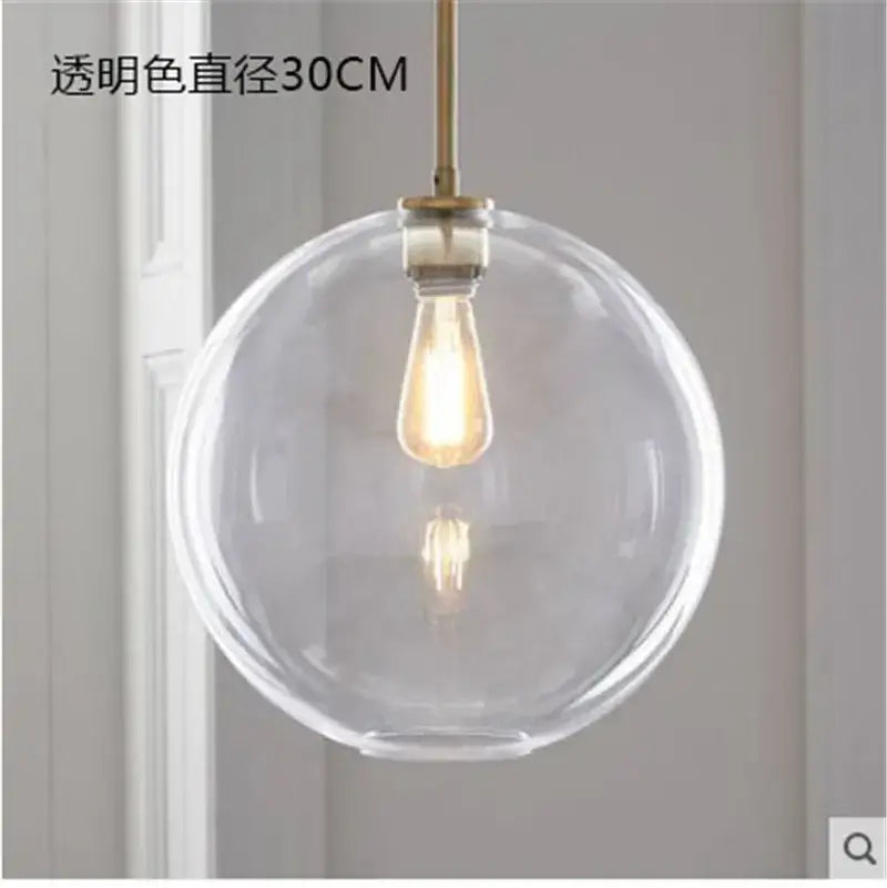 Modern amber glass ball led pendant light with clear spherical glass ball and brass-finished decorbites glass ball rod