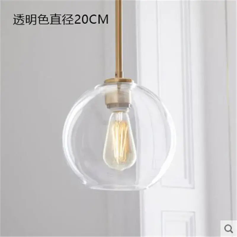 Modern amber glass ball led pendant light with clear glass globe, brass rod, and exposed filament bulb for kitchen decorbites decor