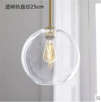 Modern amber glass ball led pendant light featuring clear glass globe with brass rod and exposed filament bulb decorbites glass ball