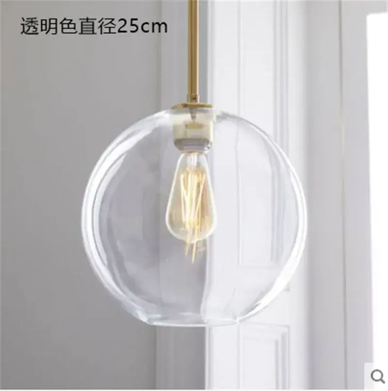 Modern amber glass ball led pendant light featuring clear glass globe with brass rod and exposed filament bulb decorbites glass ball
