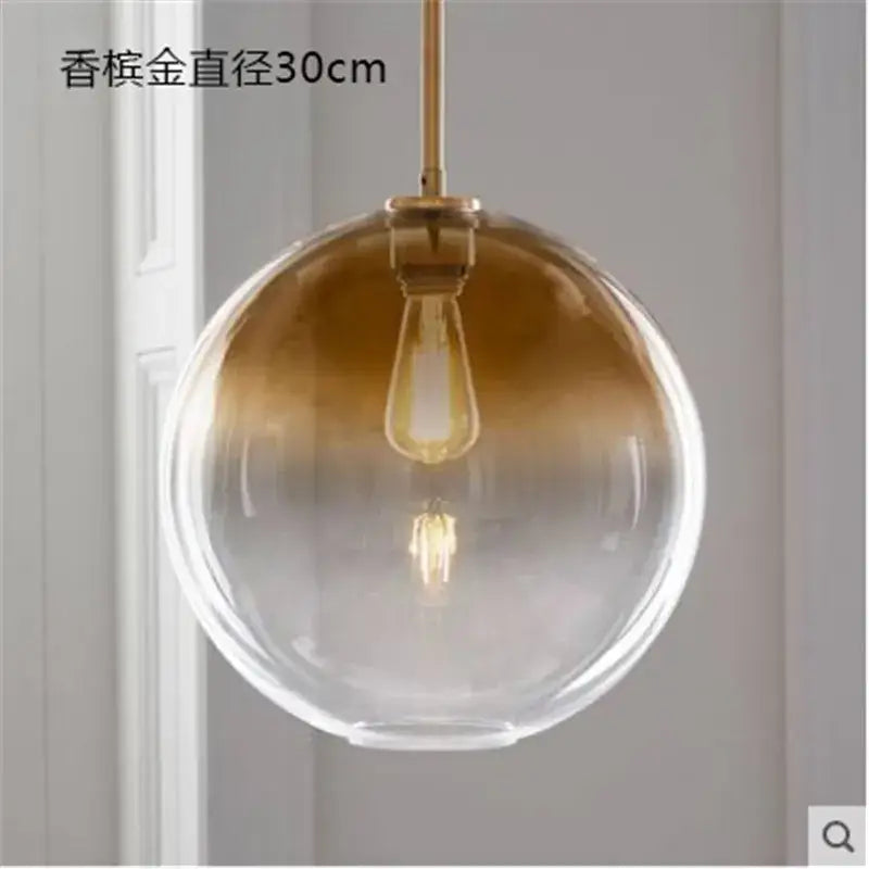 Modern amber glass ball led pendant light with gradient gold-to-clear finish and brass hardware for kitchen decorbites decor