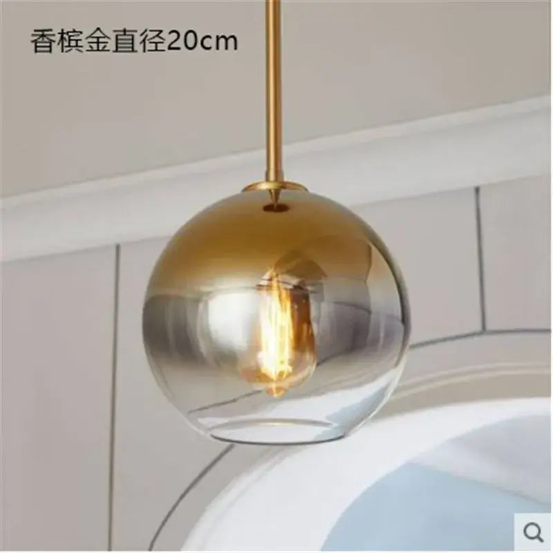 Modern amber glass ball led pendant light with gradient gold to clear finish and brass rod for kitchen decorbites decorbites glass ball
