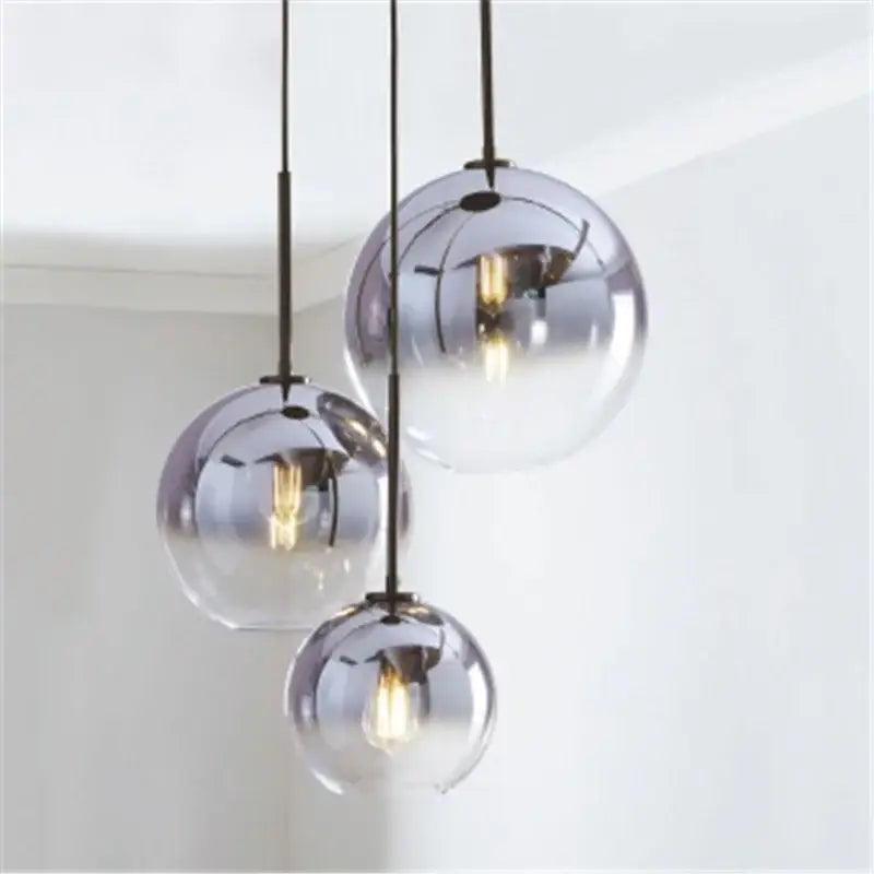 Modern amber glass ball led pendant light with metallic finish and visible filament bulbs for kitchen decorbites glass ball decor