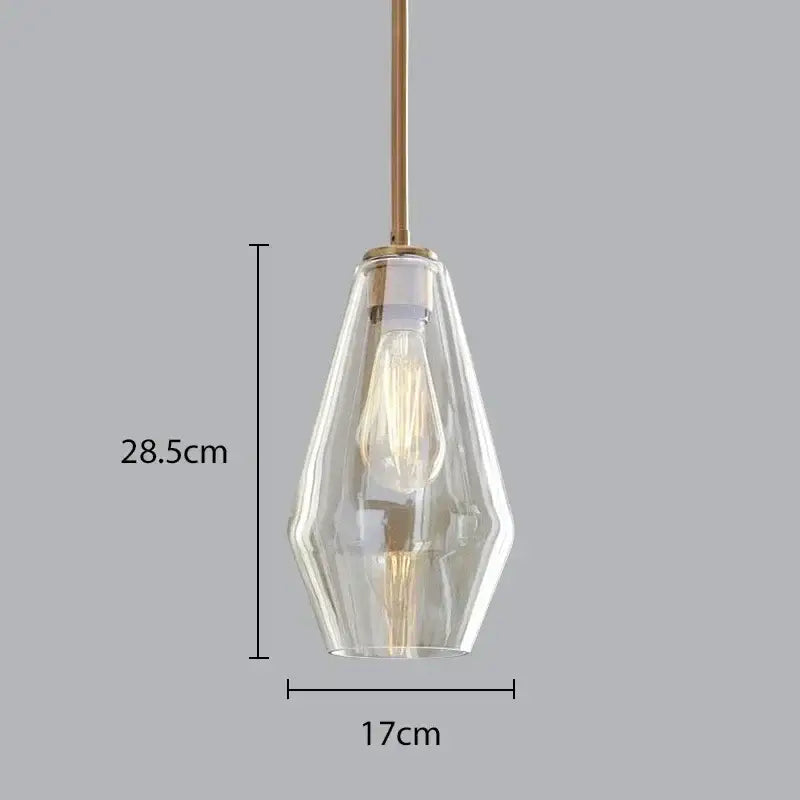 Modern amber glass chandelier with a clear faceted glass pendant light and brass stem for living room or dining room